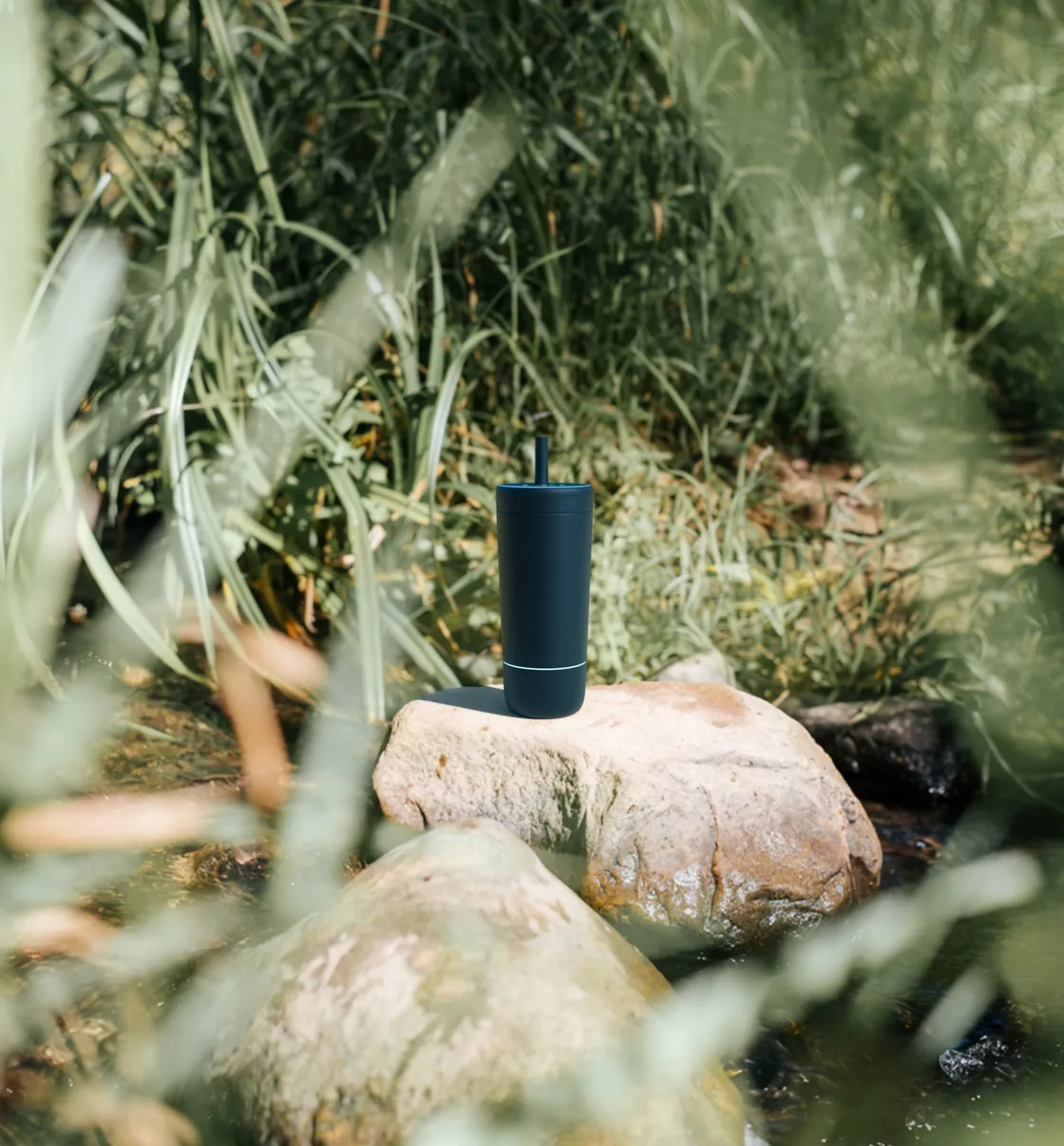 Quantum Bottle in Midnight on a rock by a stream
